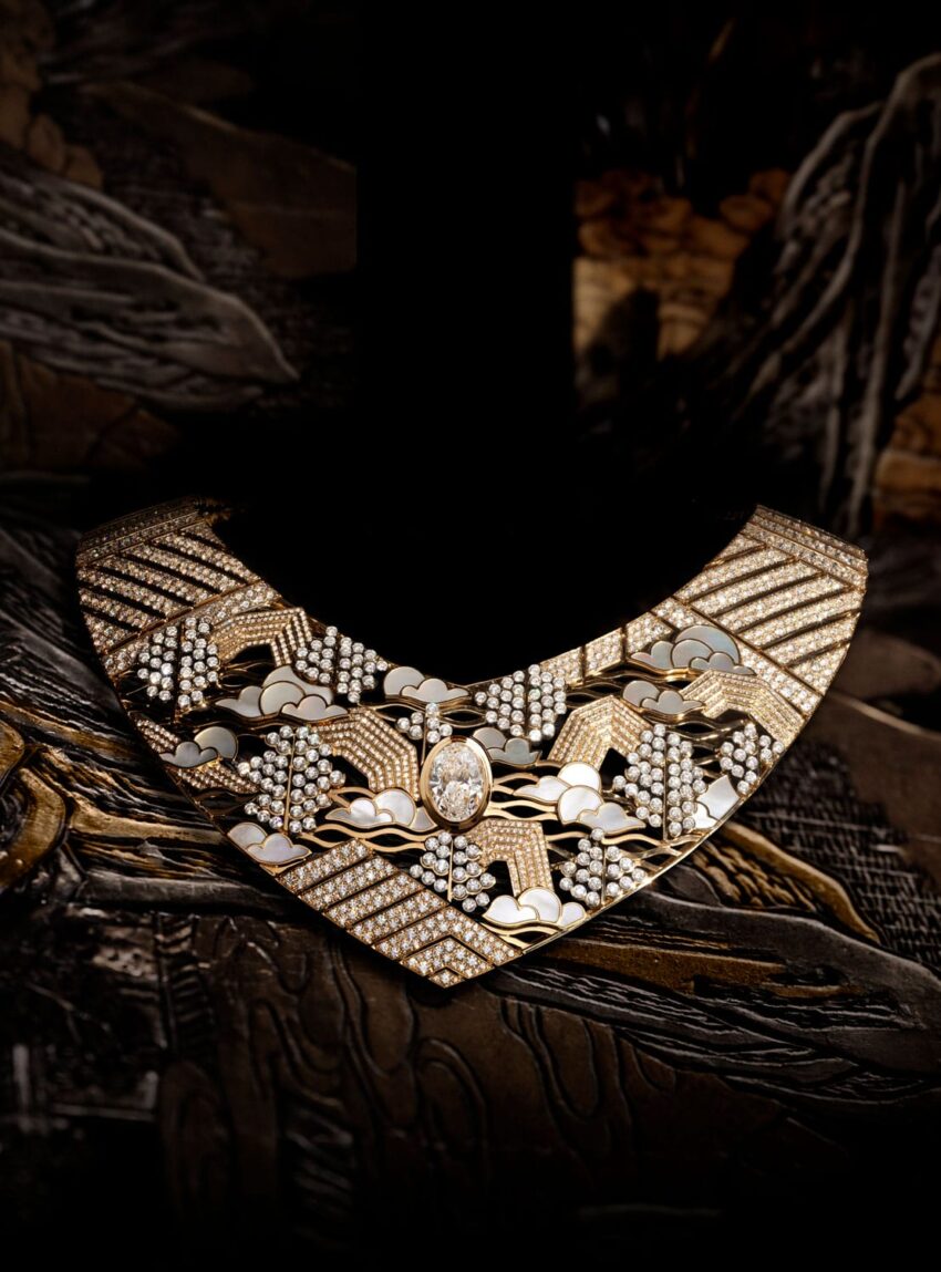 Luxurious diamond and gold necklace with intricate design set against a dark, artistic background.