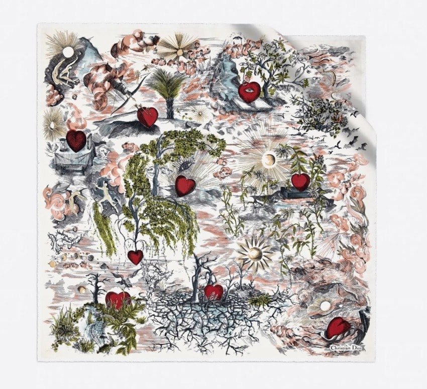 Intricate scarf design featuring hearts, nature elements, and artistic embellishments on a light background.