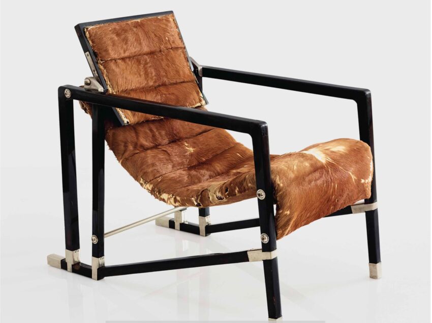 Modern black metal chair with brown fur padding on seat and backrest.