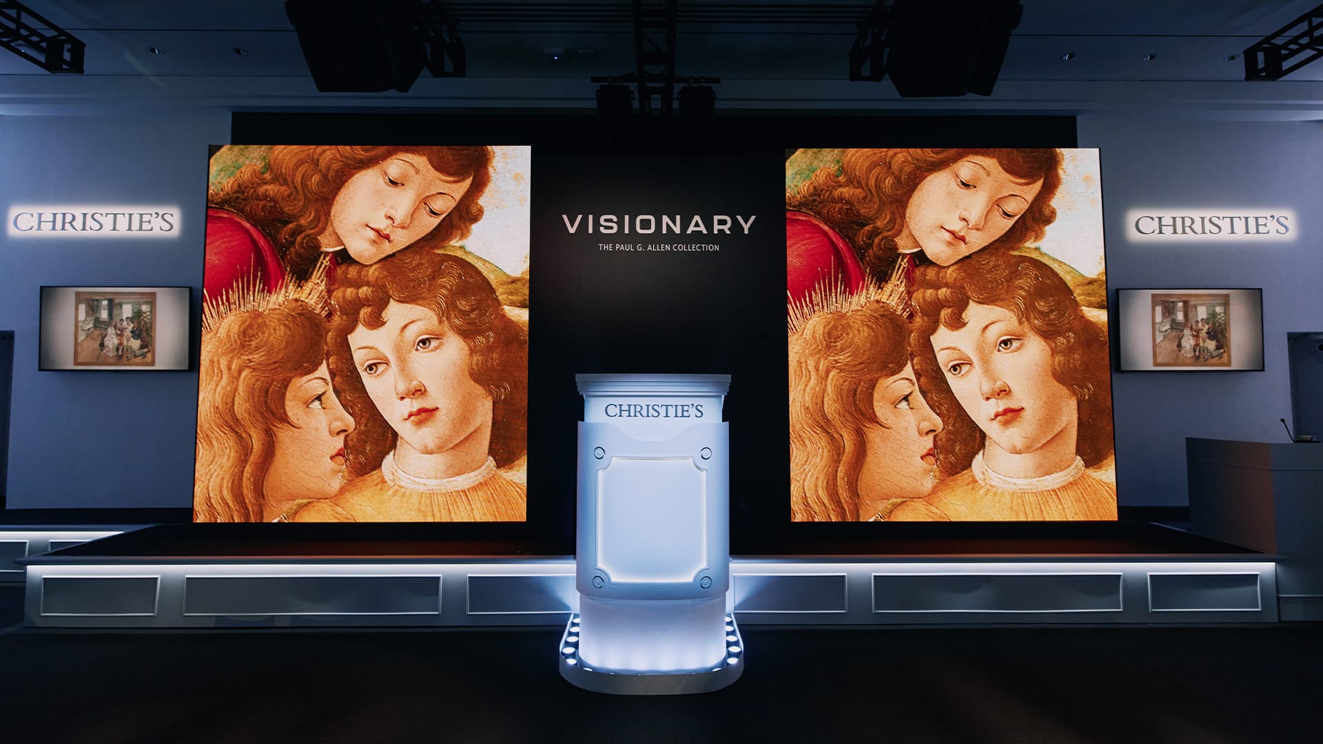 Art exhibition display with three Renaissance-style portraits and a podium at Christie's gallery.