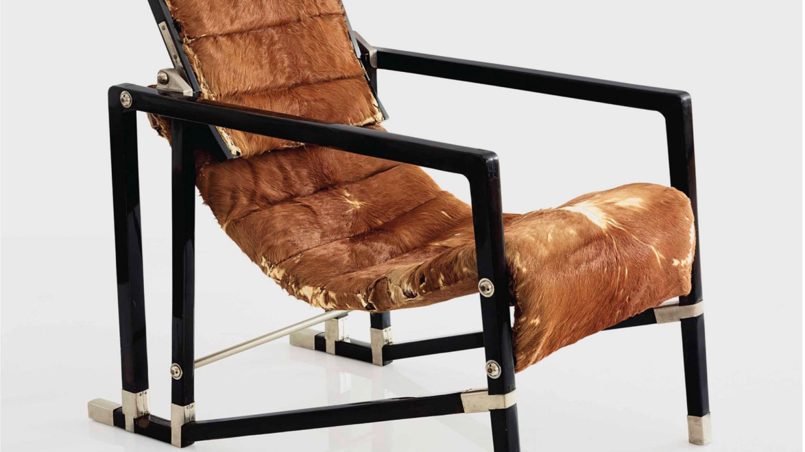 Modern black metal chair with brown fur padding on seat and backrest.