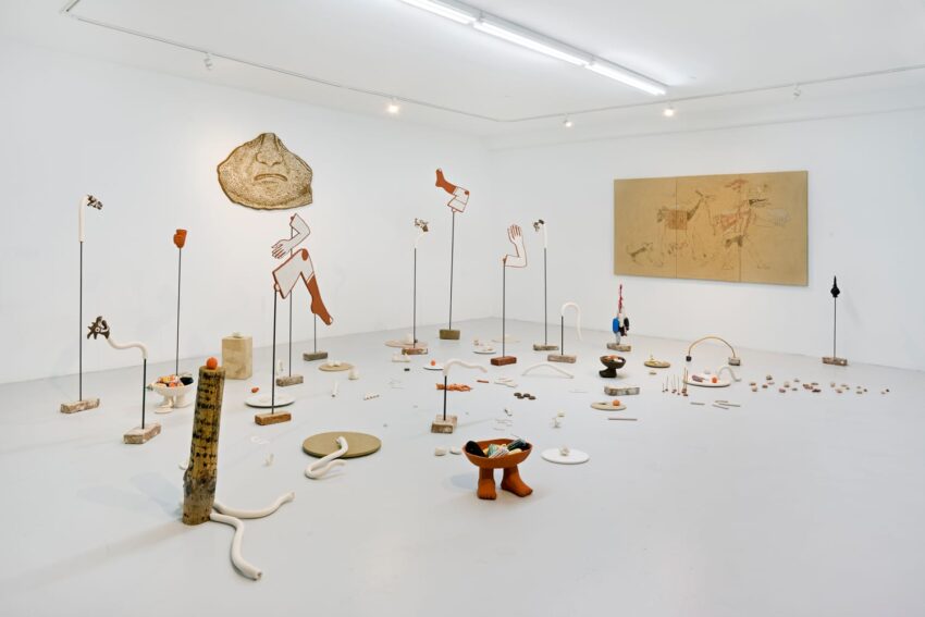 art gallery installation with abstract sculptures on white floor and walls