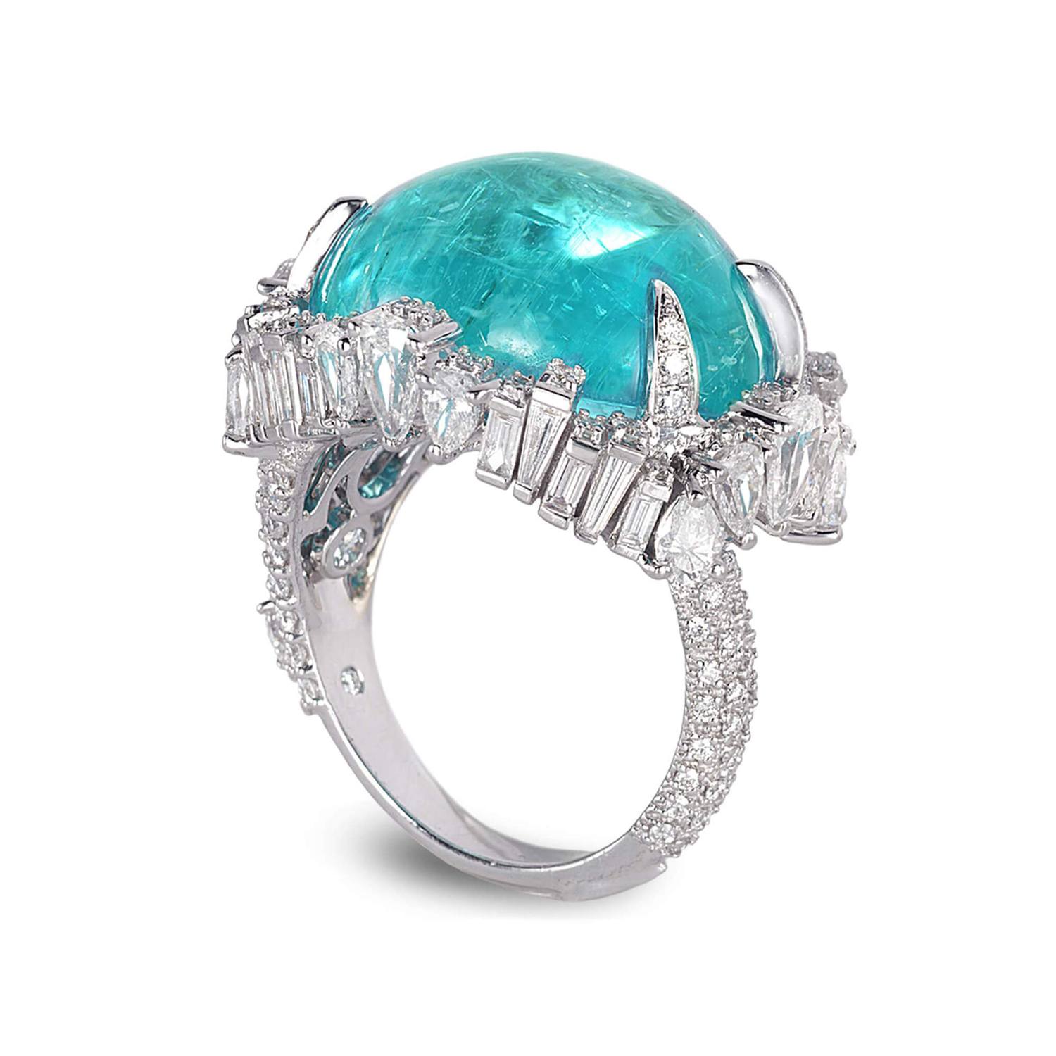 Silver ring featuring a large round blue gemstone surrounded by sparkling diamonds on band and setting