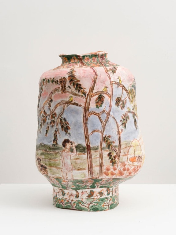 Handcrafted ceramic vase with nature scene, depicting trees, birds, and a person observing under a sky background.