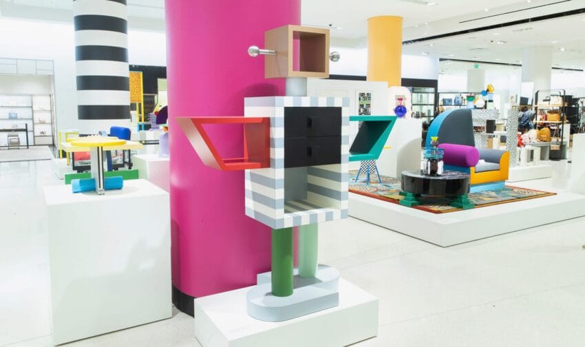 Colorful abstract sculpture resembling a robot in a modern art exhibition with various vibrant furniture pieces.