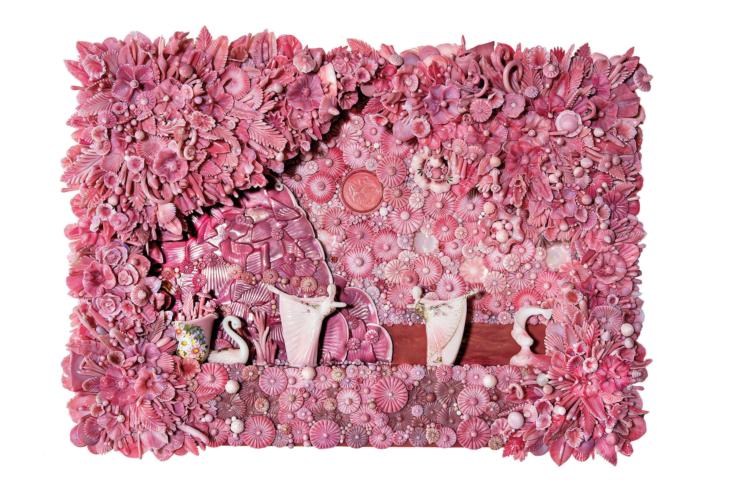 Intricate pink wall art composed of various textured materials forming floral and ornamental patterns in a rectangular frame.
