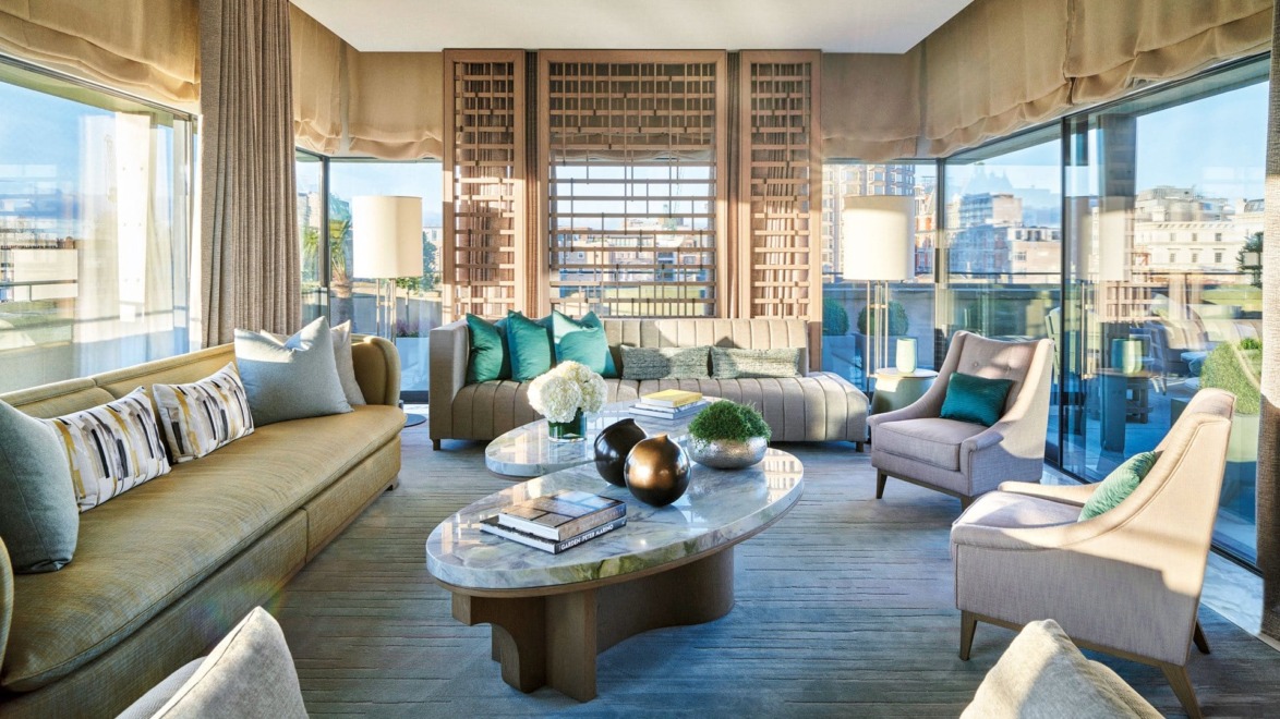 Modern living room with large windows, elegant furniture, and stylish decor.