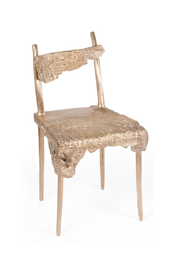 Modern artistic chair with a textured, irregular gold finish and unique sculptural design.