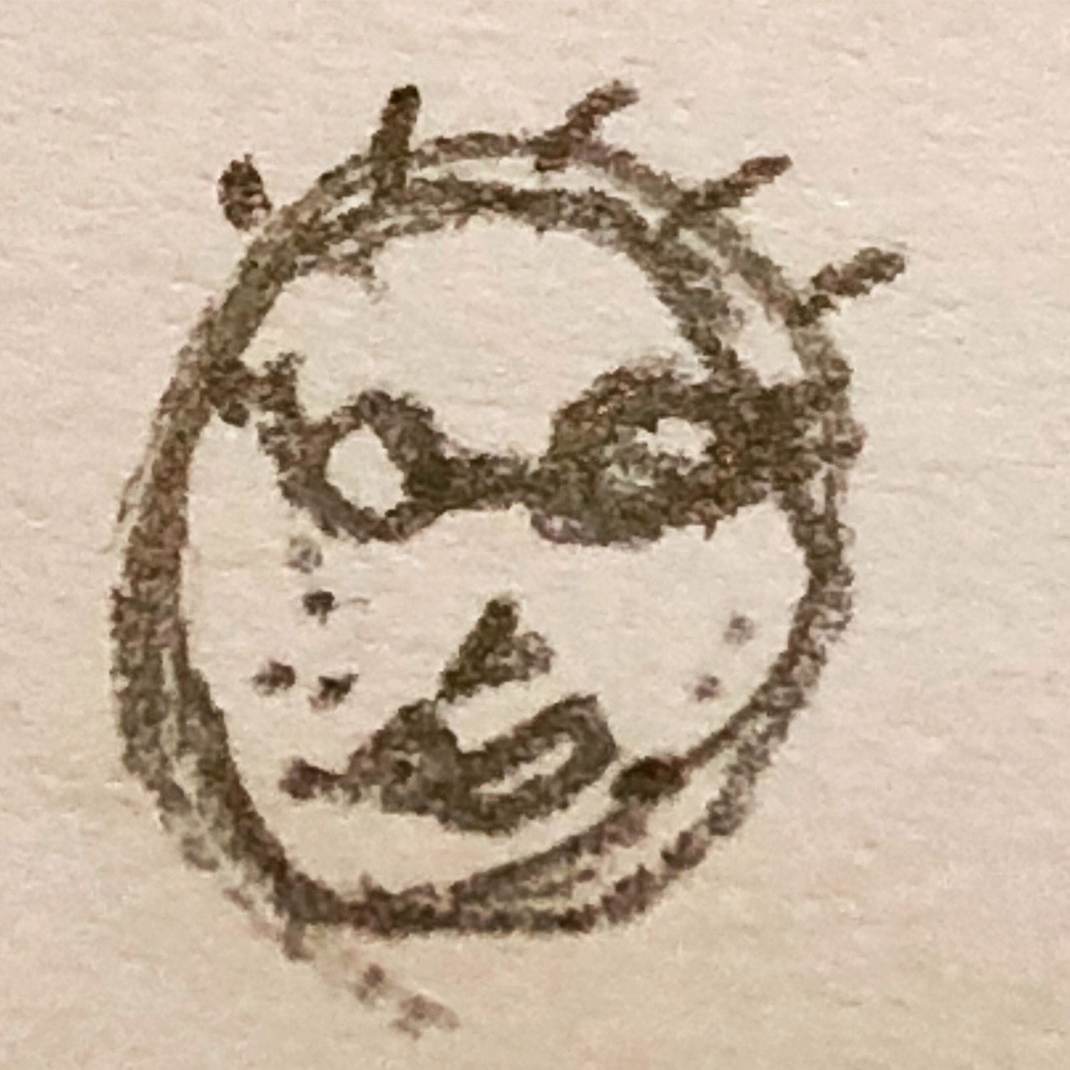Simple hand-drawn face with spiky hair and a playful expression on a textured paper background.