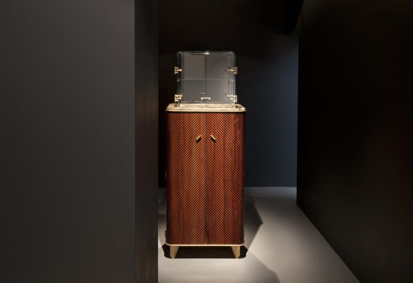 Luxurious wooden cabinet with a transparent top in a dimly lit room.