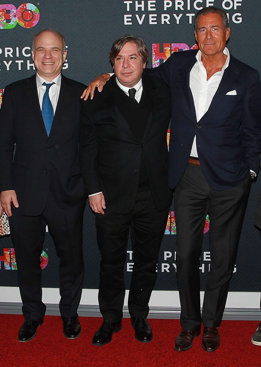 Three men in suits standing on a red carpet at an event with "The Price of Everything" HBO backdrop.