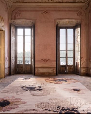 ornate room with floral-patterned rug and tall windows letting in natural light