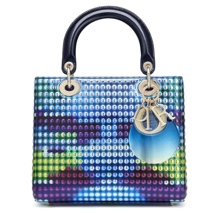 Colorful handbag with a digital pixel design and metal charms hanging from the handle.
