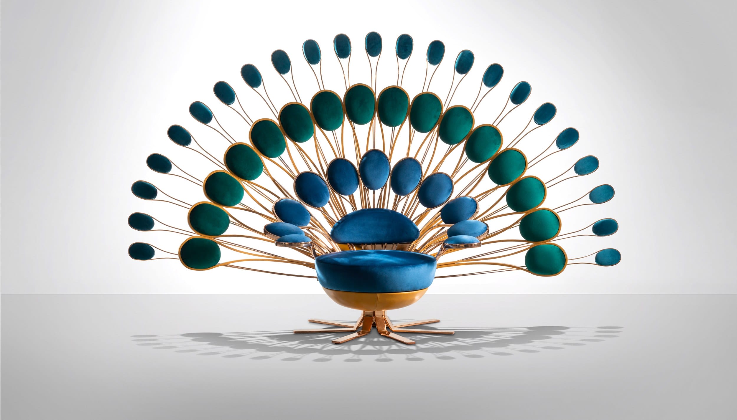 Peacock-inspired chair with blue and green details, featuring a unique fan design against a white background.