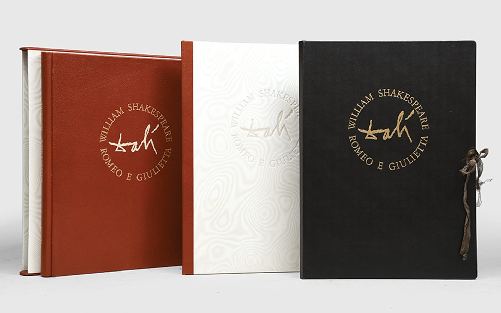 Three editions of Romeo and Juliet by William Shakespeare with unique cover designs displayed upright.