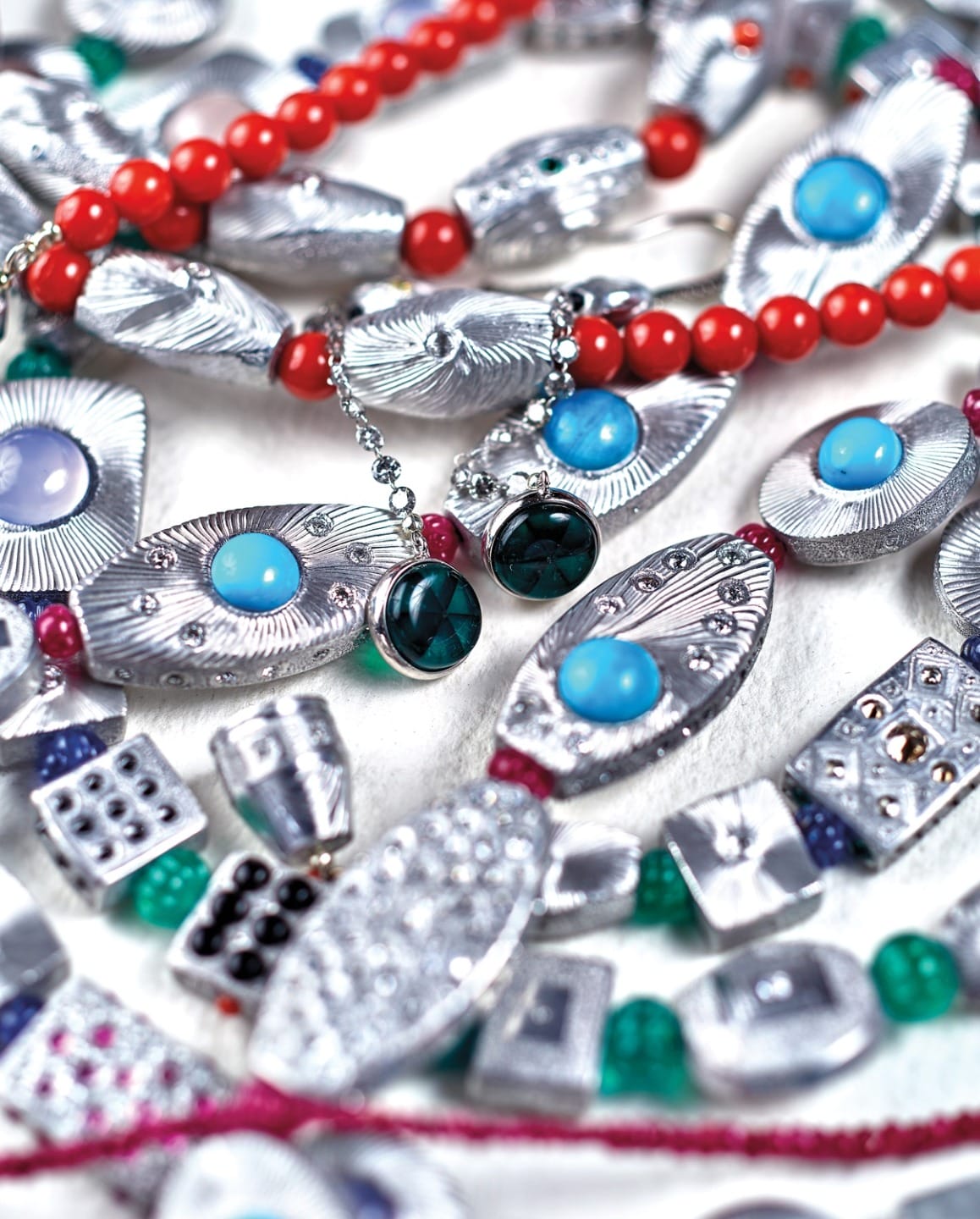Colorful, intricate beaded jewelry with silver, red, blue, and green accents on display.