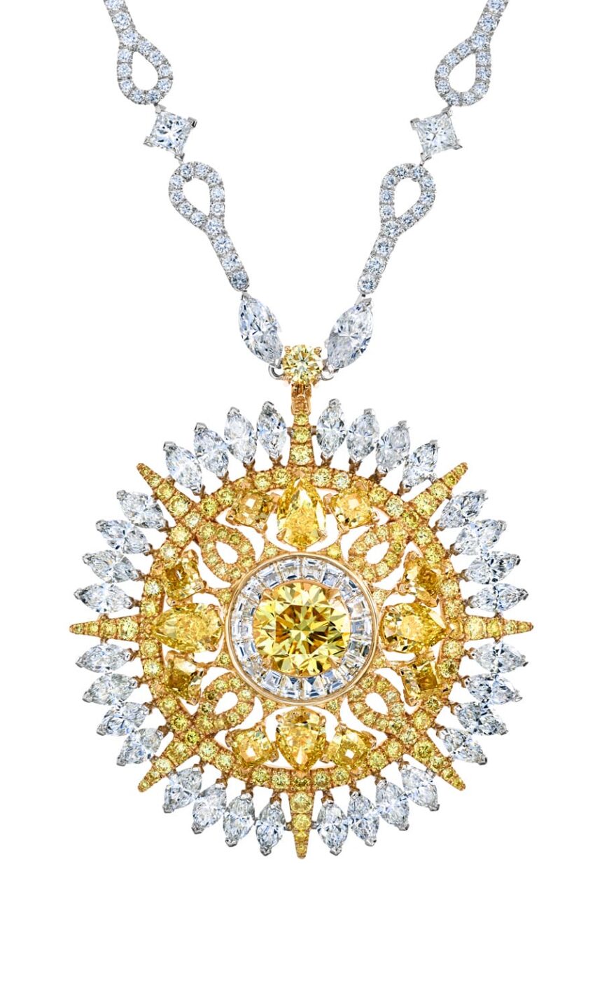 Intricate gold and diamond necklace with a large sunburst-shaped pendant featuring a central yellow gemstone.