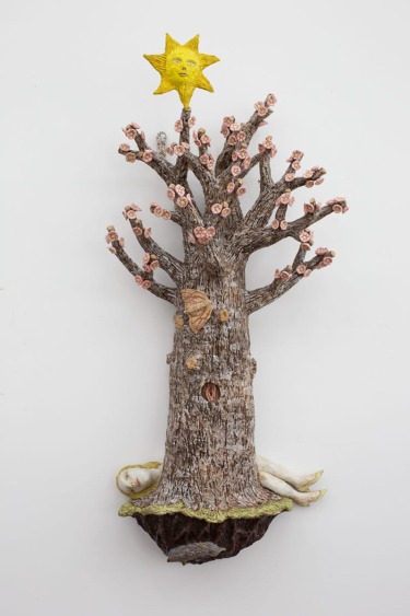 Surreal artwork of a textured tree with a woman's face, flowers, yellow star above, and a reclining figure at the base.