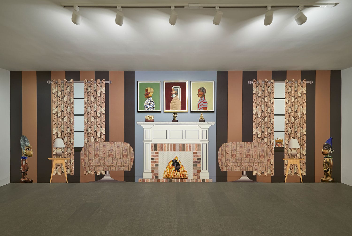 Art installation with a painted living room scene, featuring a fireplace, patterned chairs, and portraits above the mantel.