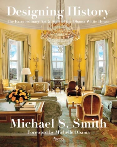 Cover of "Designing History" by Michael S. Smith, featuring an elegant room with yellow walls and a grand chandelier.