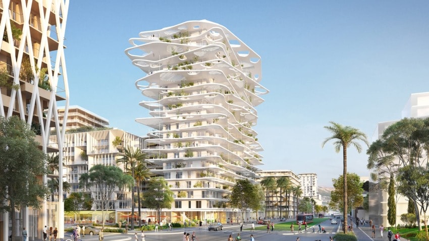 Futuristic white high-rise building with circular balconies, surrounded by palm trees and cityscape on a sunny day.