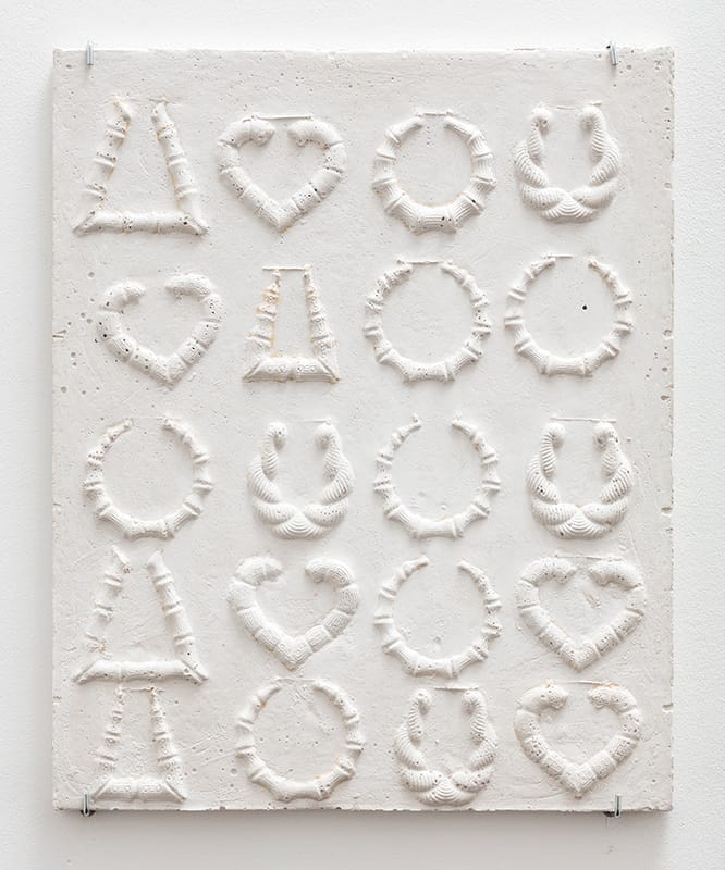 Abstract artwork on a textured white canvas with patterns resembling circles, hearts, and triangles in relief form.
