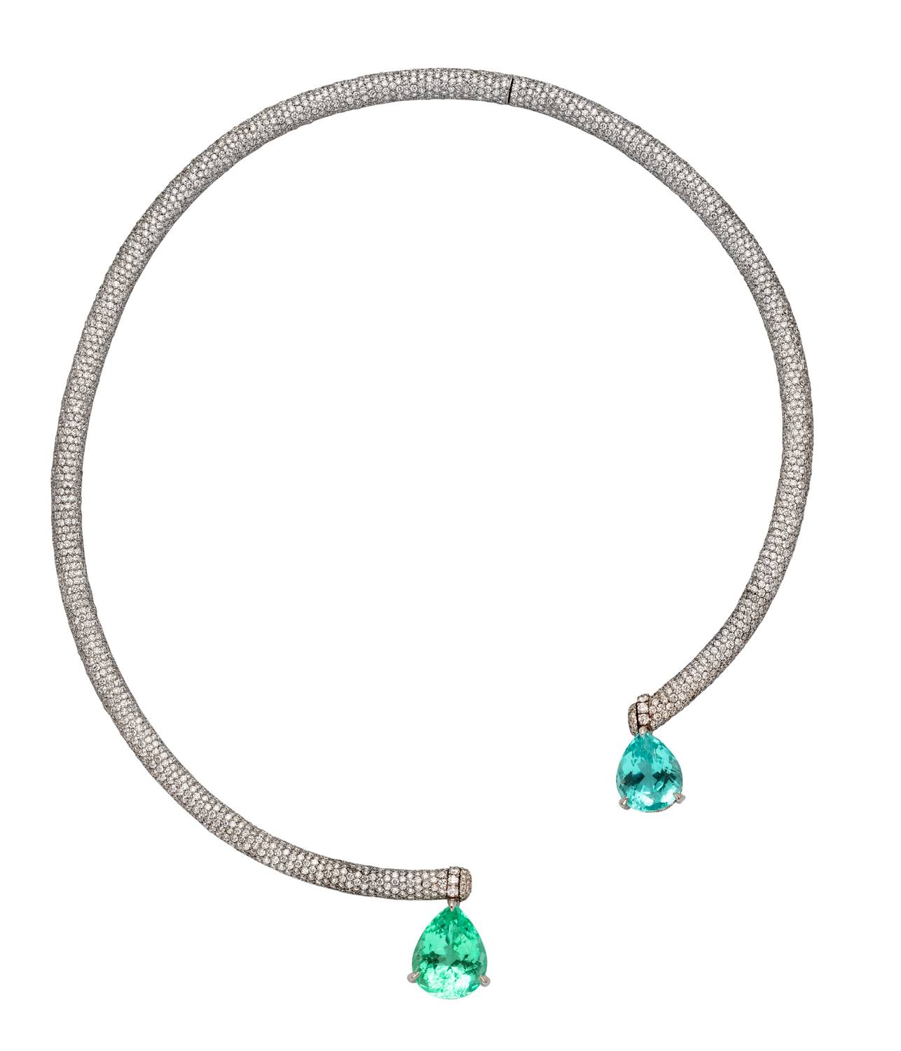 Elegant white gold necklace with two pear-shaped green gemstones at the open ends on a white background.