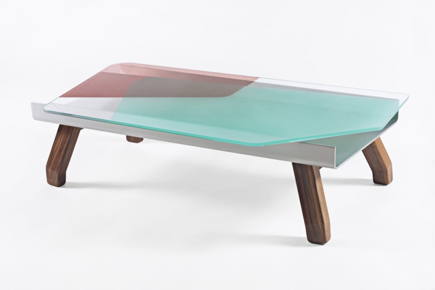 Modern glass coffee table with wooden legs and a colorful geometric glass top design on a white background.