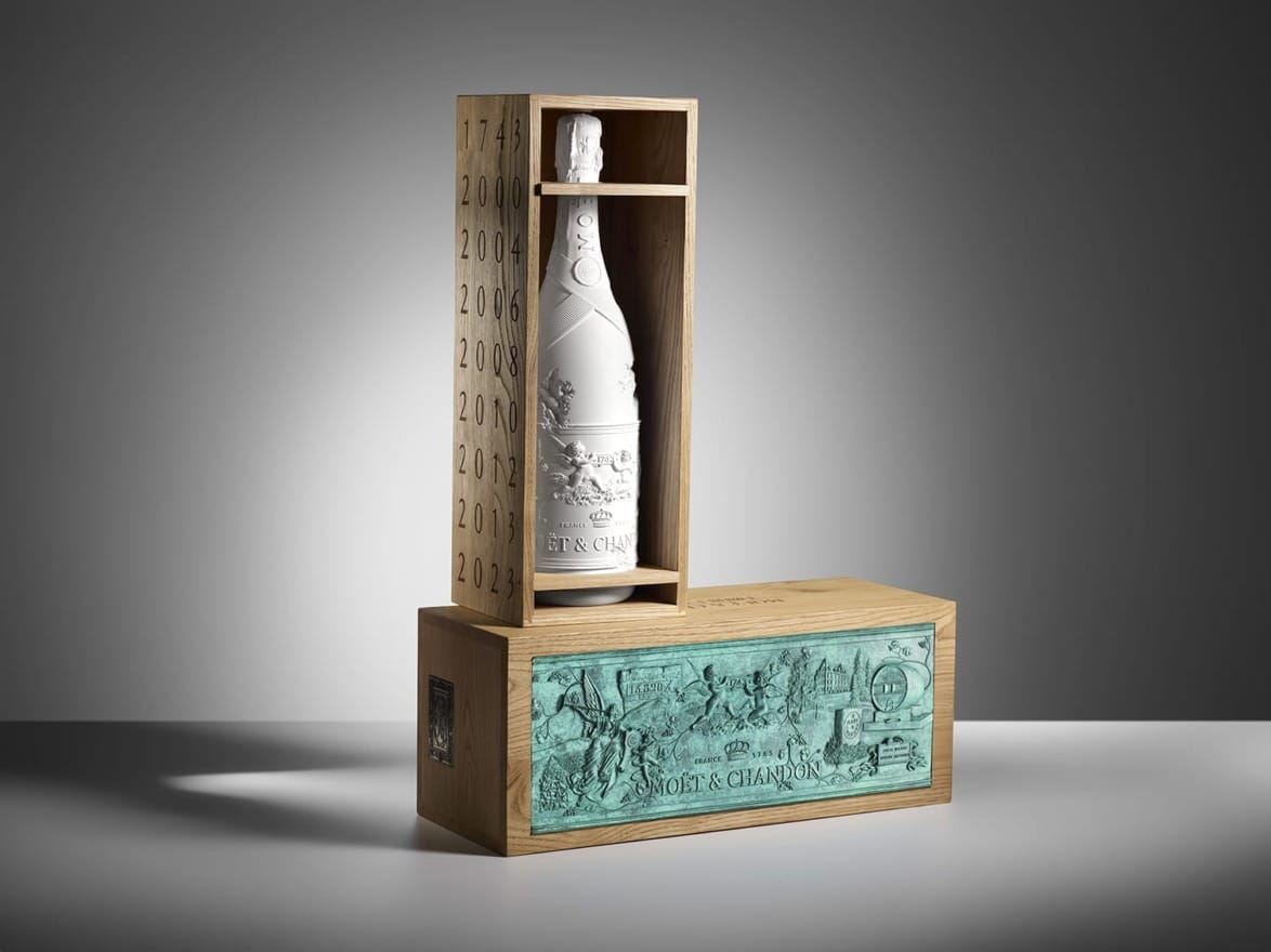 elegant champagne bottle in decorative wooden box with Roman-themed engraving and embossed vintage years