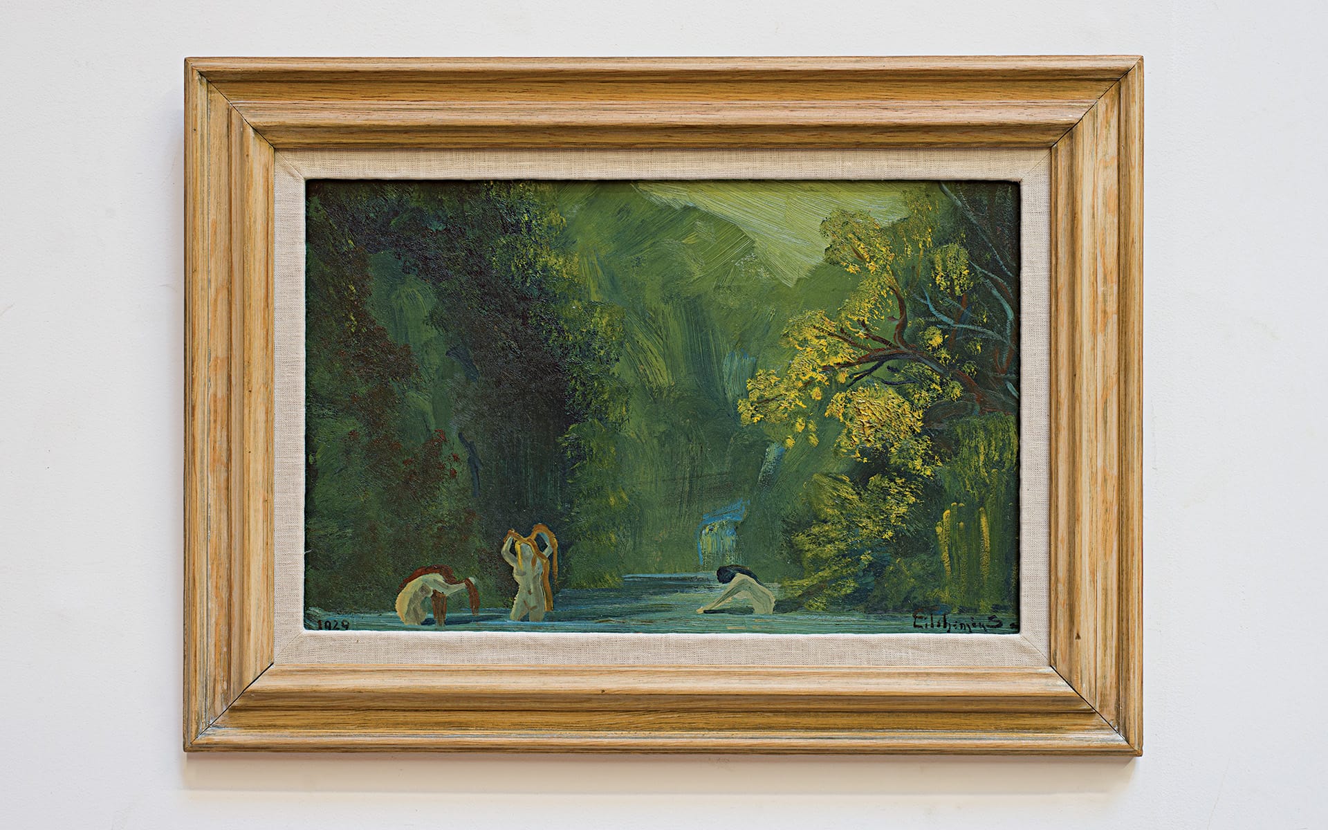Framed painting of a serene forest scene with three figures in a clearing surrounded by lush greenery.