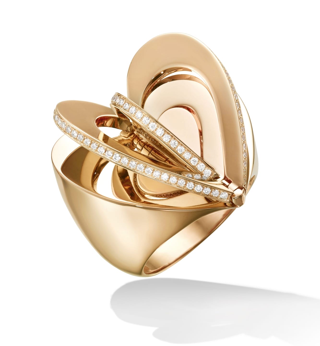 Gold statement ring with abstract design and diamond accents against a white background.