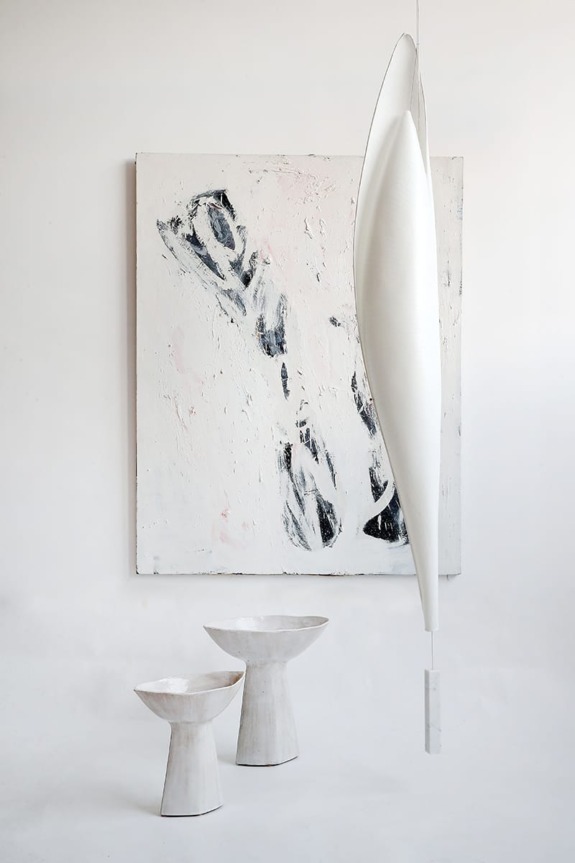Modern abstract painting with two white ceramic vases on a minimalist background.