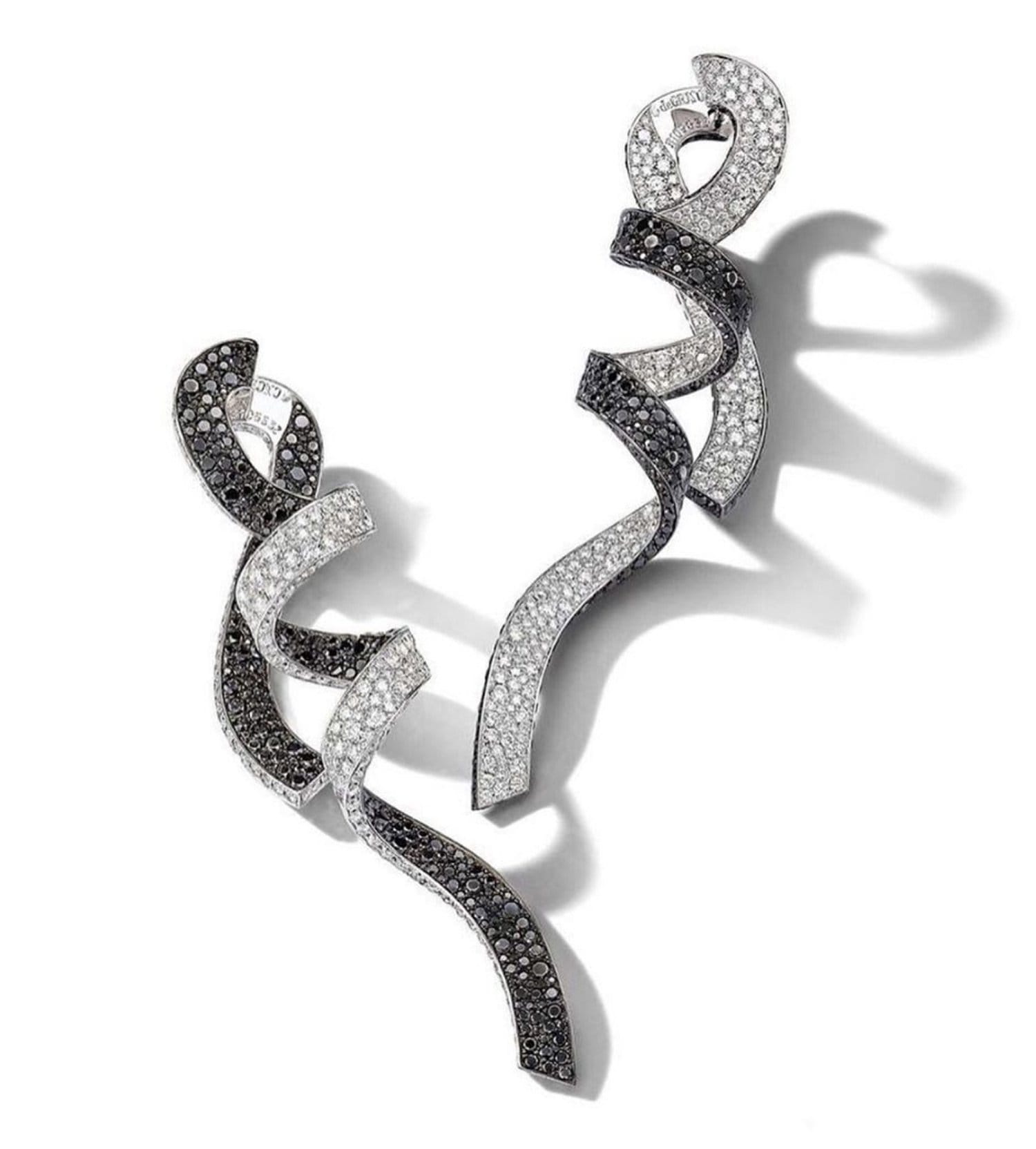 Black and white twisted diamond earrings displayed on a white background.