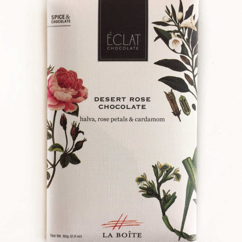 Éclat chocolate bar with rose and cardamom designs on packaging, labeled Desert Rose Chocolate, spice and chocolate blend.