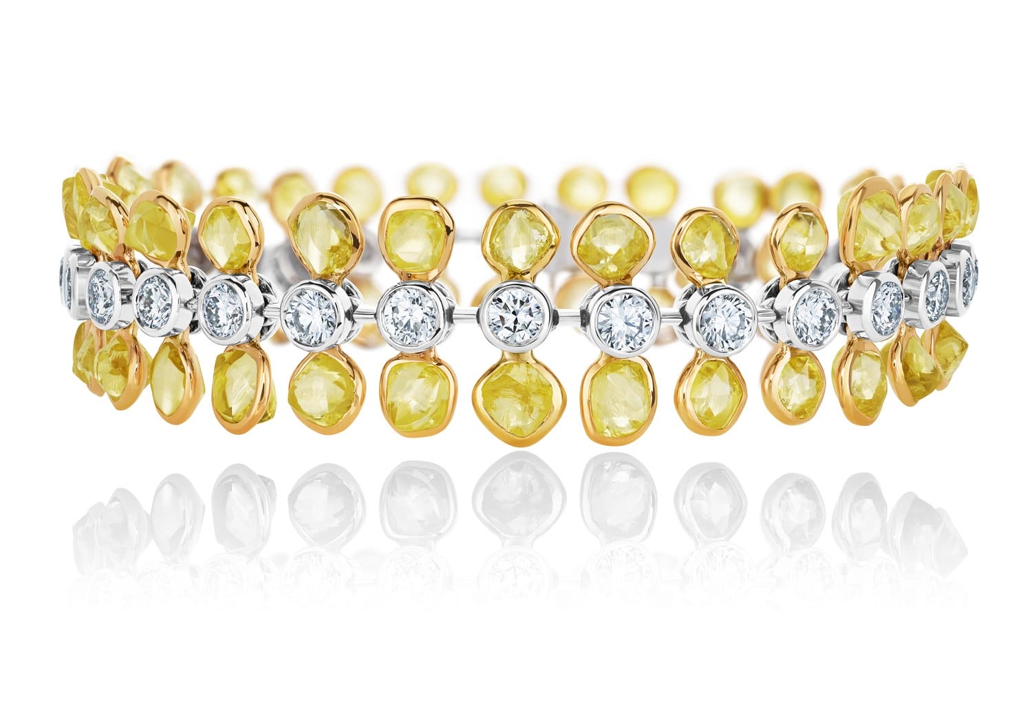 Yellow and white gemstone bracelet with reflective surface.