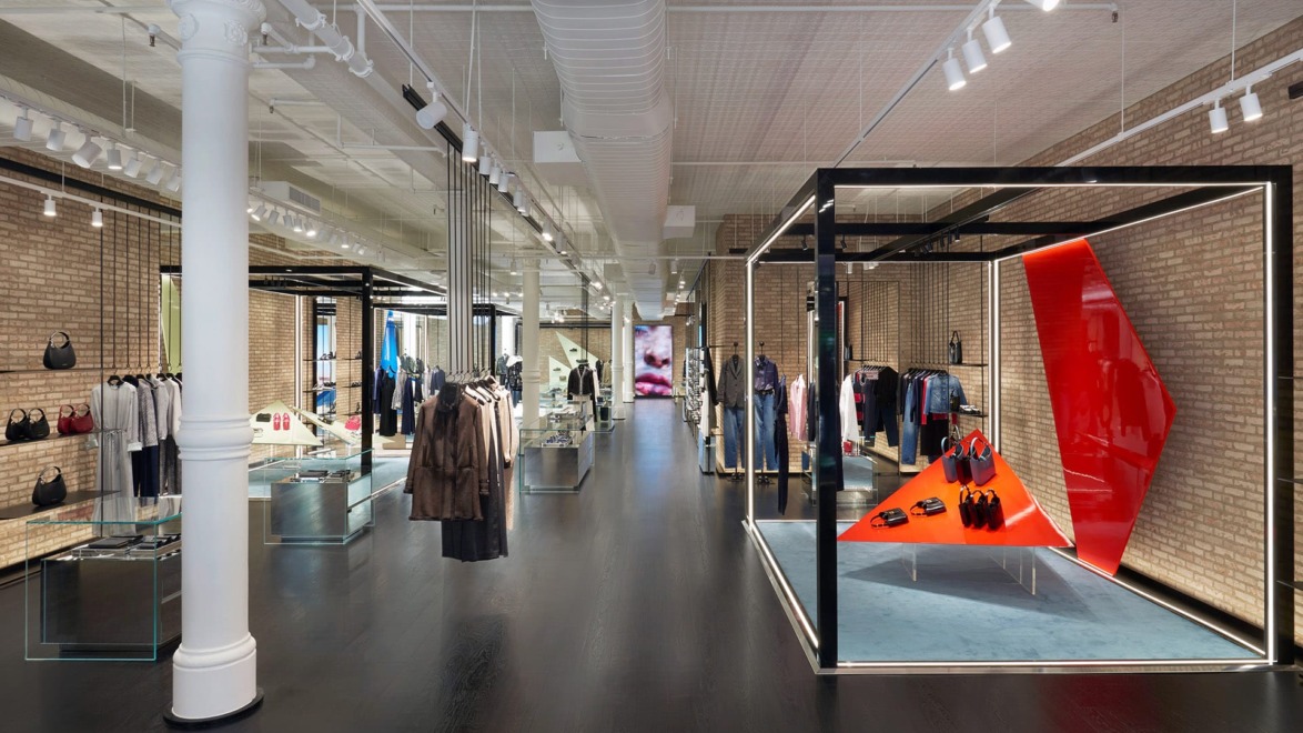 Modern clothing store interior with stylish displays, racks of clothing, and bright lighting.