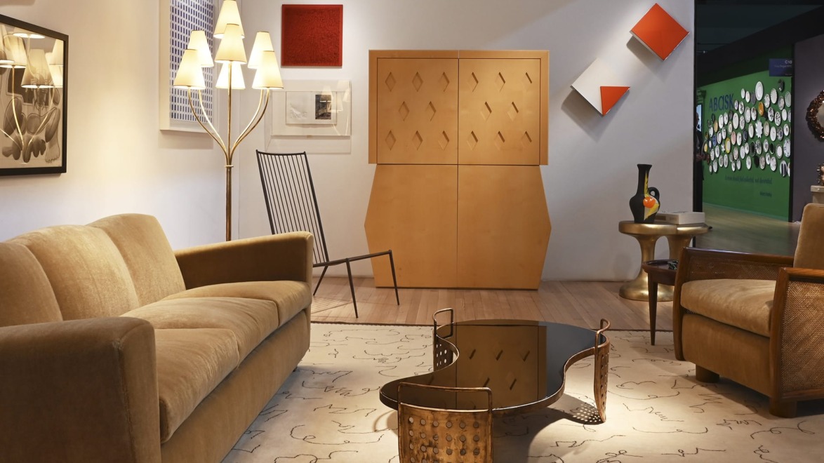 Mid-century modern living room with beige sofas, abstract art, geometric decor, and a wooden coffee table.
