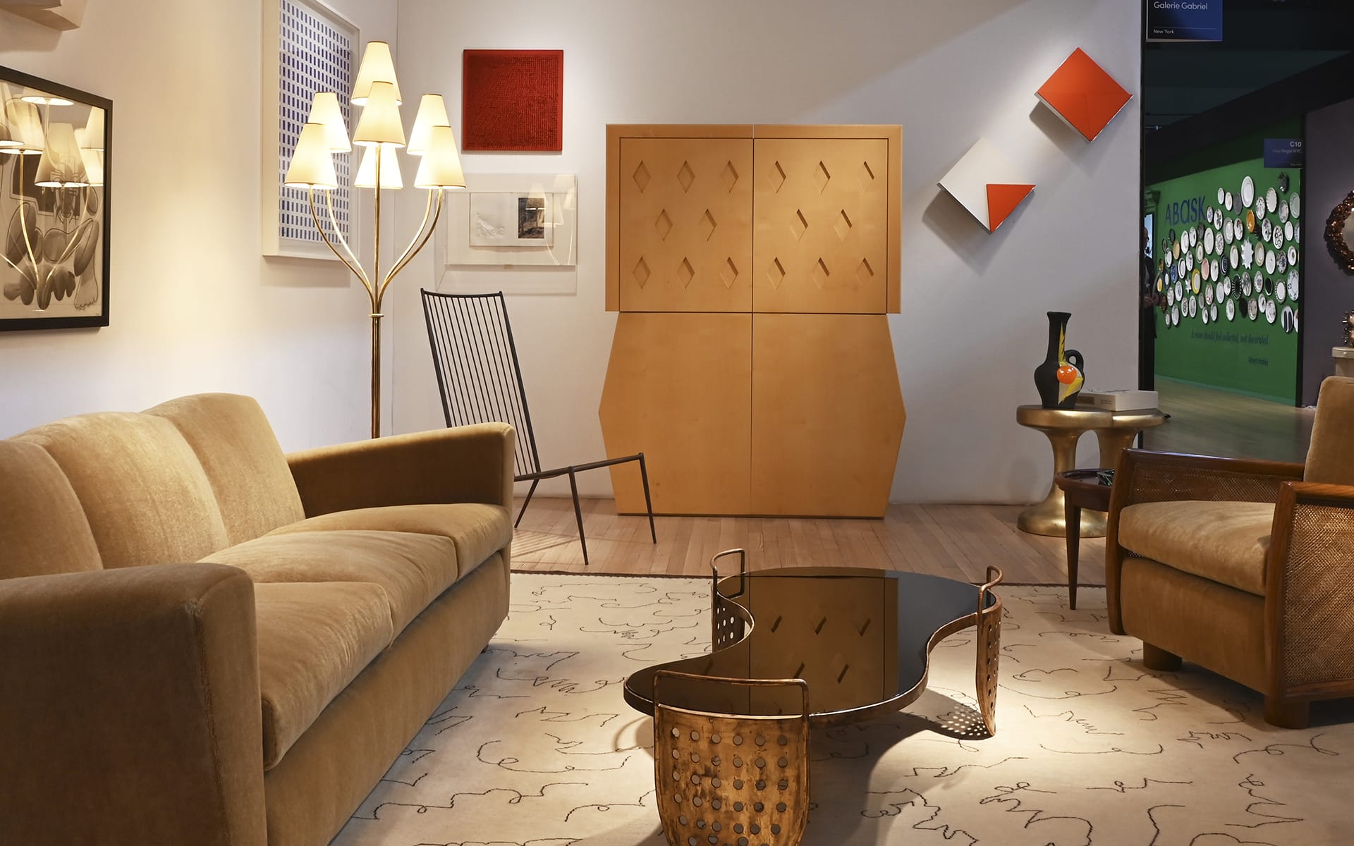 Mid-century modern living room with beige sofas, abstract art, geometric decor, and a wooden coffee table.