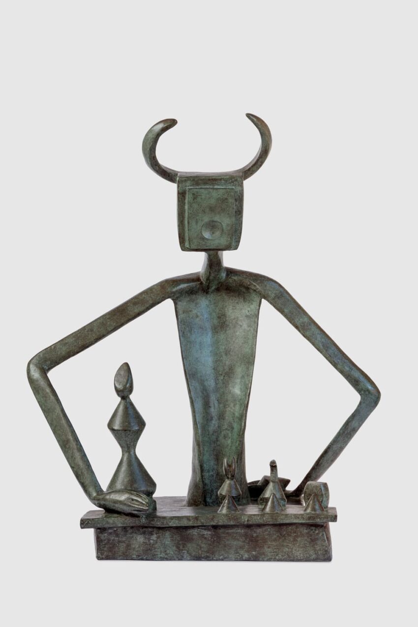 Bronze abstract sculpture of a horned figure with geometric shapes and elongated arms on a rectangular base.