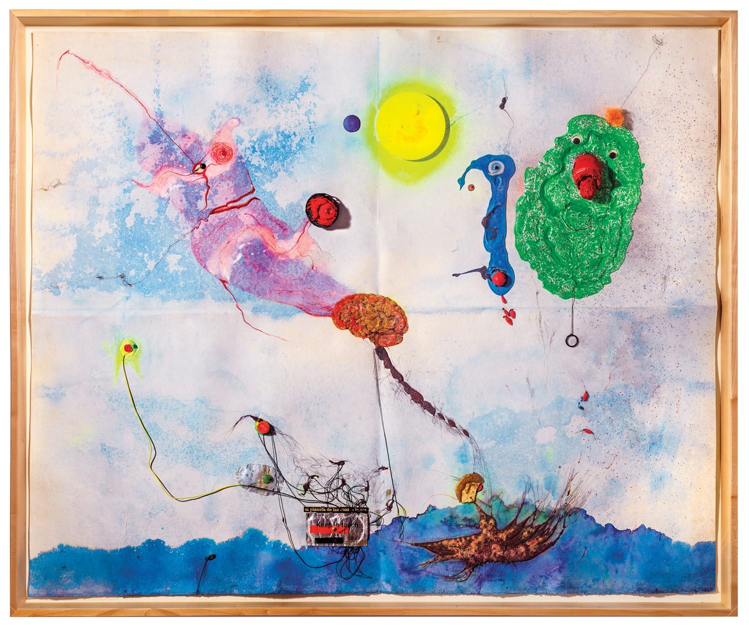 Colorful abstract painting with vibrant shapes, a sun-like circle, and various whimsical figures against a light blue background.