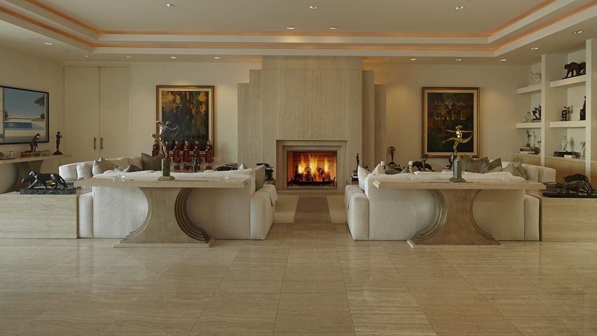 Luxurious living room with marble floors, elegant sofas, a modern fireplace, and artwork on walls.