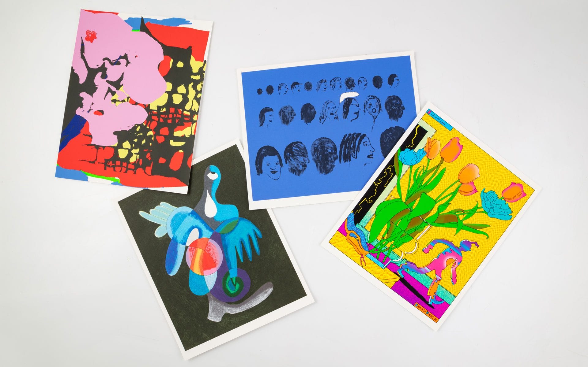 Four colorful abstract art prints displayed on a white surface, featuring various shapes and vibrant colors.