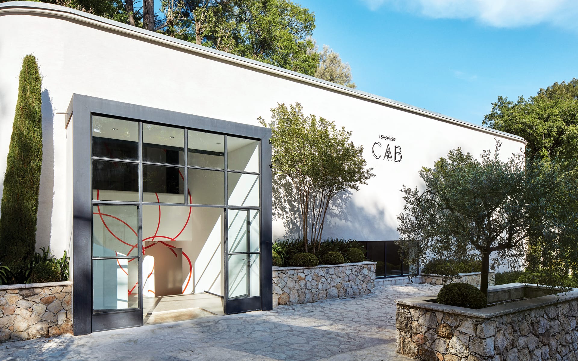 Exterior view of Anderson CAB art gallery with modern architecture and trees surrounding the entrance.