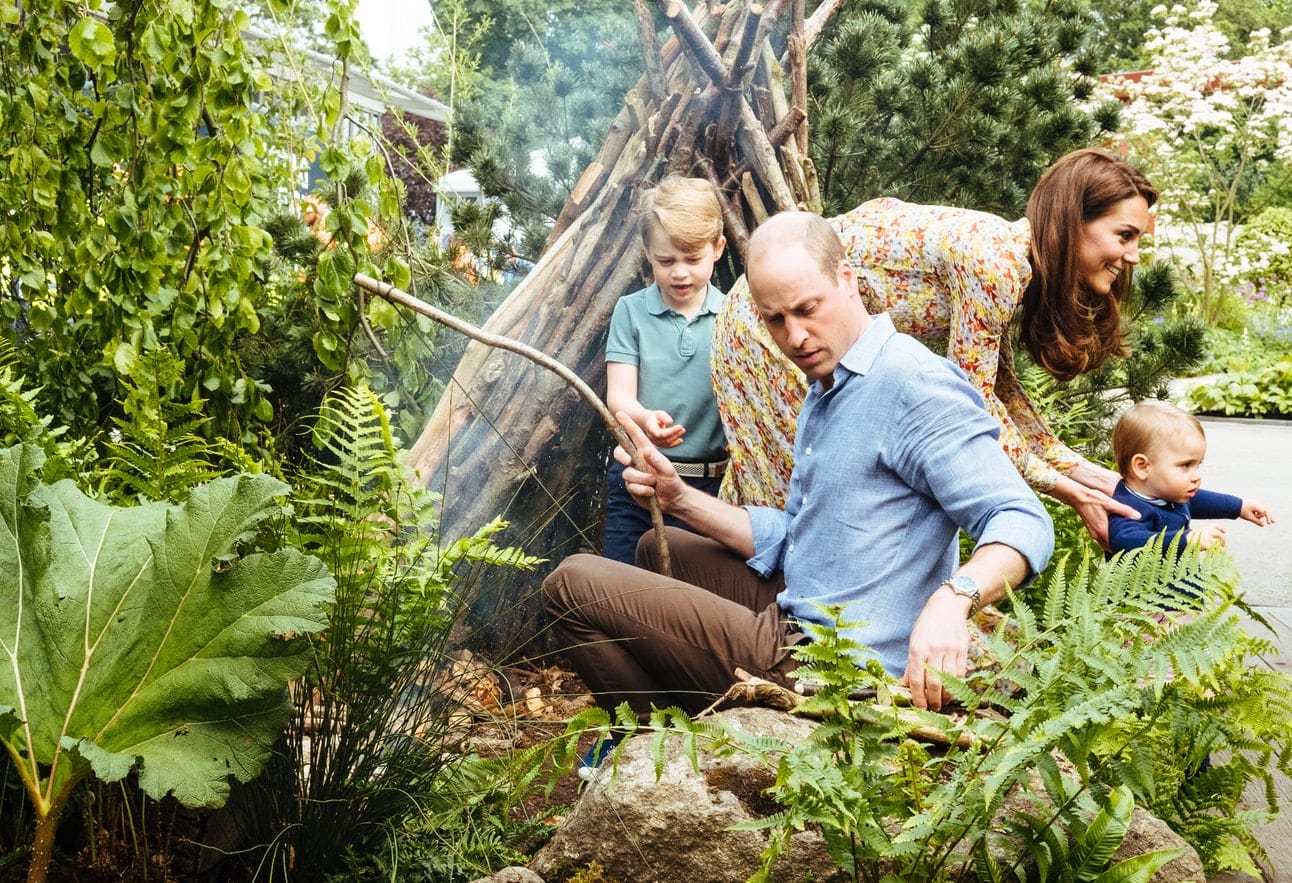 A family enjoying a garden outing, with adults tending to plants and children exploring nature.