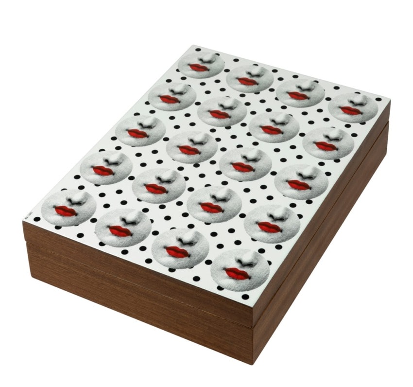 Decorative box with a pattern of faces featuring red lips on a white background with black dots, wooden sides visible.