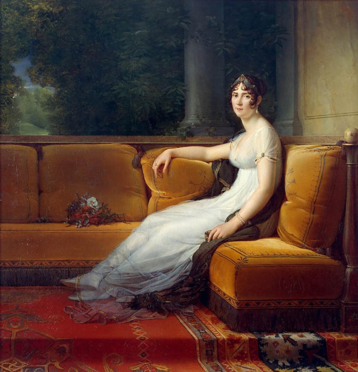 Woman in a white dress sitting on a yellow sofa in a historical setting, surrounded by a lush garden background.