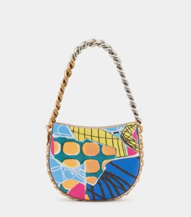 Colorful patchwork handbag with silver and gold chain handle, featuring abstract geometric and floral patterns.