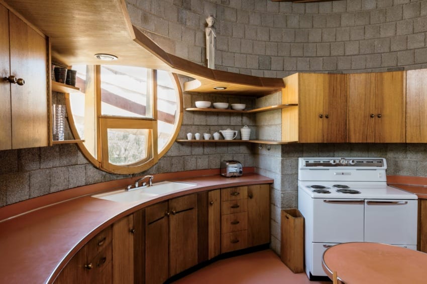 The kitchen, also referred to as Work Space, by Wright, includes distinct circular windows pre-dating the geometry of future buildings