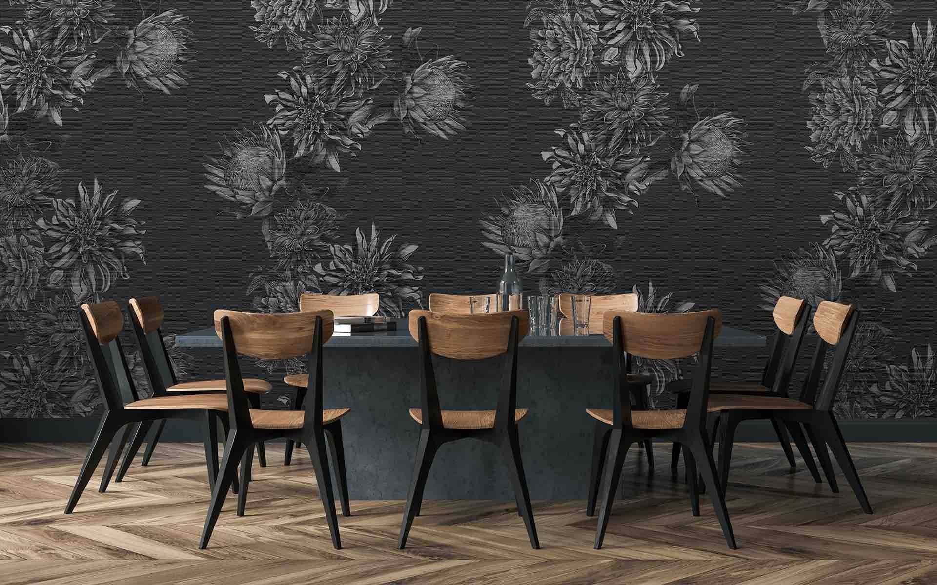 Dining table with eight chairs against a dark floral wallpaper in a modern room with wooden flooring.