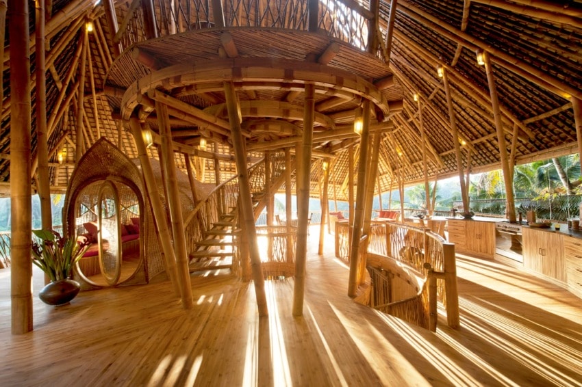 Interior of a bamboo eco-friendly structure with stairs and natural lighting, showcasing sustainable architecture.